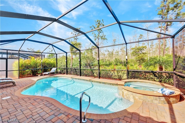 view of pool with a lanai, an in ground hot tub, and a patio