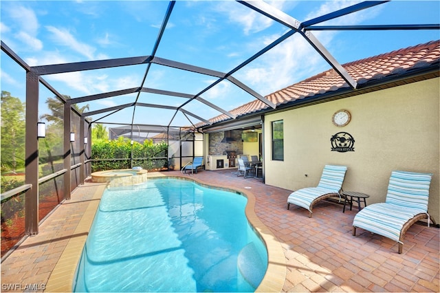 view of swimming pool featuring glass enclosure, an in ground hot tub, and a patio