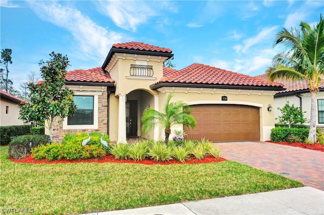 mediterranean / spanish house featuring a garage and a front lawn