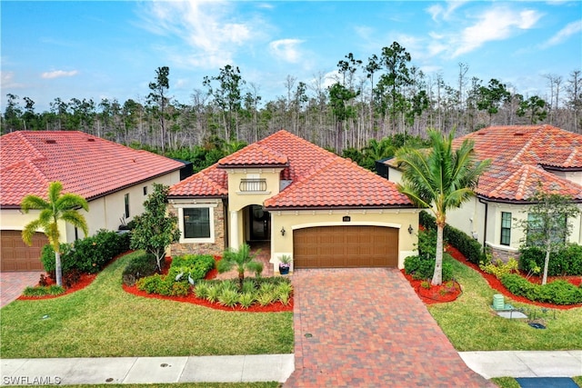 mediterranean / spanish house featuring a garage and a front lawn