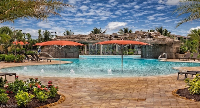 view of pool with pool water feature and a patio