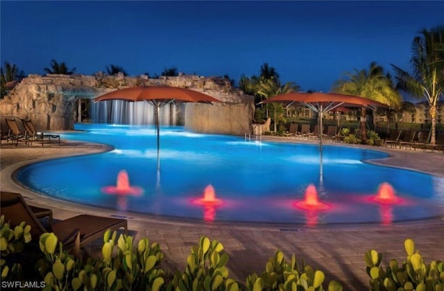 view of swimming pool featuring pool water feature and a patio