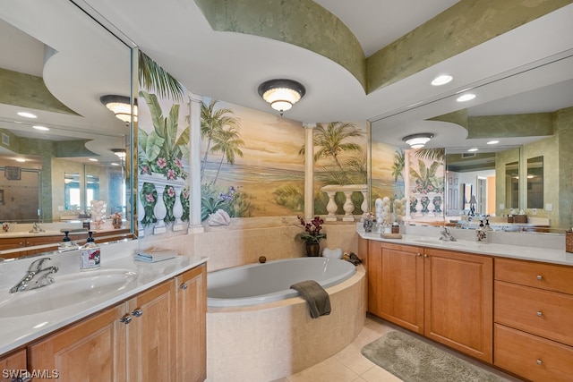 bathroom with vanity, tiled bath, and tile patterned flooring