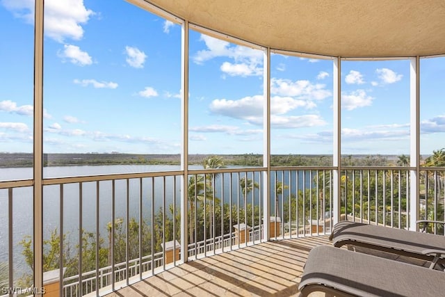 unfurnished sunroom with a water view