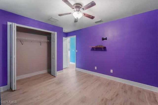 unfurnished bedroom with light wood-type flooring, a closet, and ceiling fan