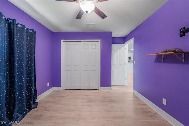 unfurnished bedroom with ceiling fan, a closet, and light hardwood / wood-style flooring