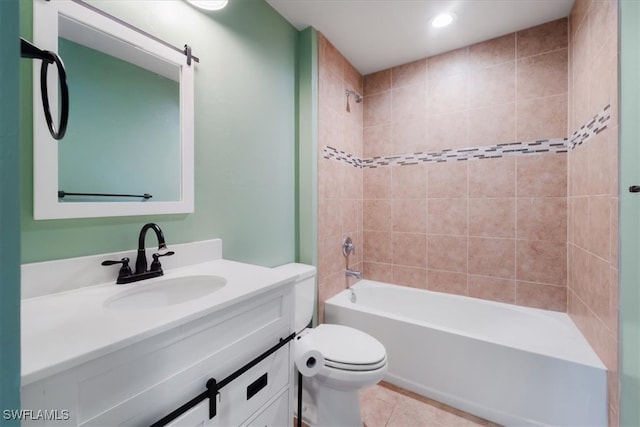 full bathroom featuring vanity, tiled shower / bath combo, tile patterned floors, and toilet