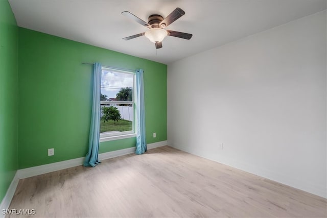 spare room featuring ceiling fan and light hardwood / wood-style flooring