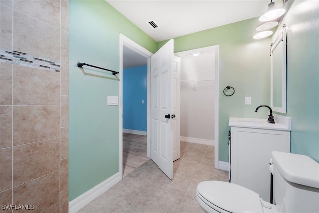 bathroom with tile patterned floors, vanity, and toilet