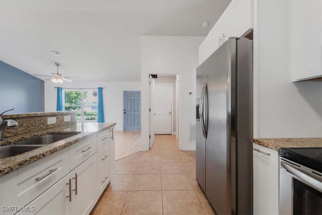 kitchen featuring white cabinets, stone countertops, sink, and stainless steel appliances