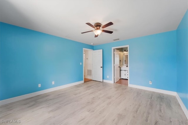 unfurnished bedroom featuring connected bathroom, light hardwood / wood-style floors, and ceiling fan