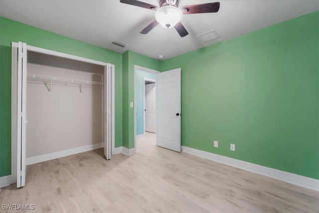 unfurnished bedroom with a closet, light hardwood / wood-style flooring, and ceiling fan