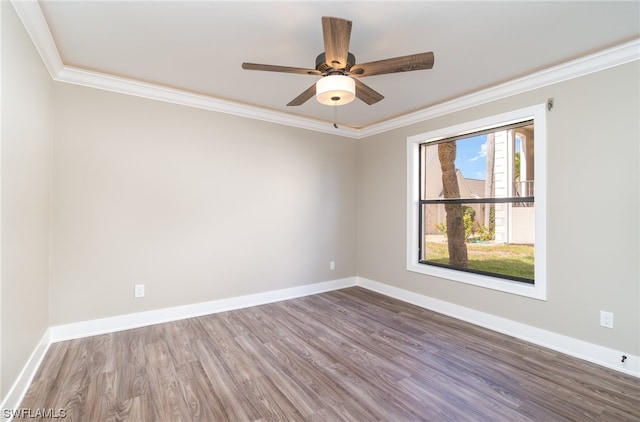 spare room with ceiling fan, ornamental molding, and dark wood-type flooring