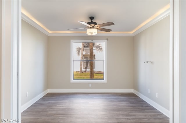 empty room featuring ornamental molding, ceiling fan, and dark hardwood / wood-style floors