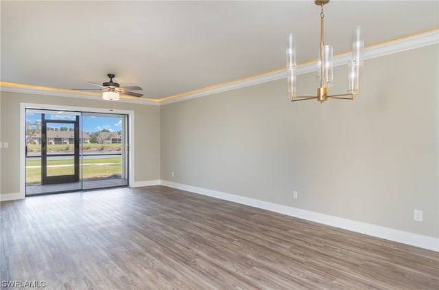 spare room with crown molding, ceiling fan with notable chandelier, and hardwood / wood-style flooring