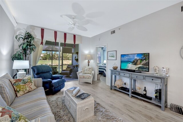 living room featuring ceiling fan and light wood-type flooring