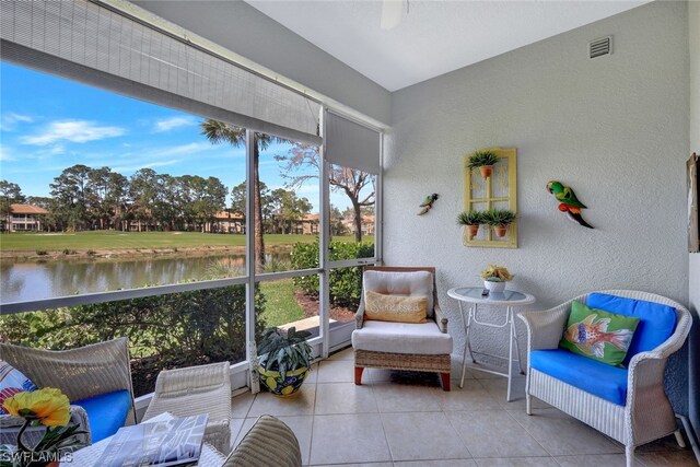 sunroom / solarium with a water view