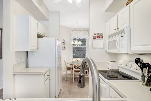 kitchen with hanging light fixtures, white appliances, white cabinetry, and light hardwood / wood-style flooring