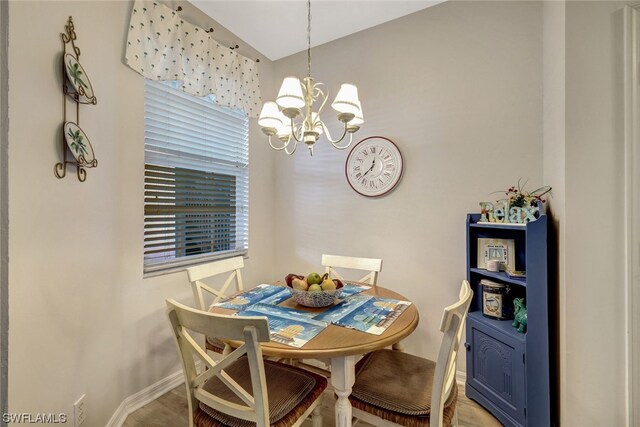 dining area featuring a notable chandelier and hardwood / wood-style flooring