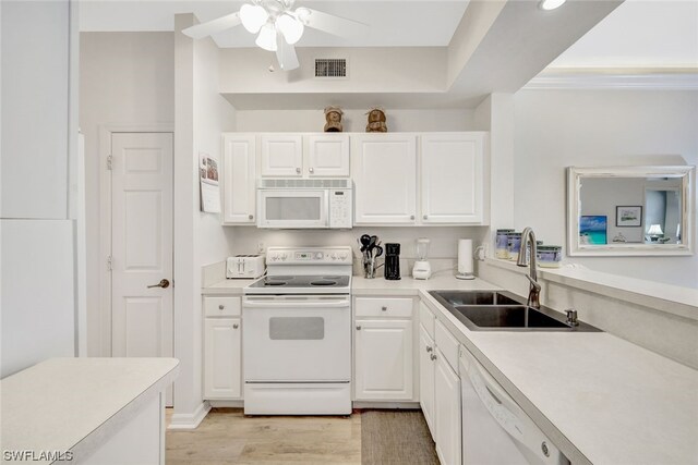 kitchen with white appliances, white cabinetry, ceiling fan, and light hardwood / wood-style flooring