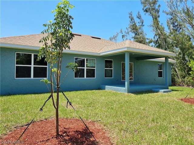 rear view of house featuring a yard and a patio