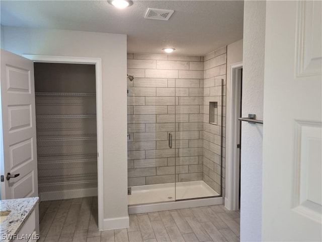 bathroom with vanity and walk in shower