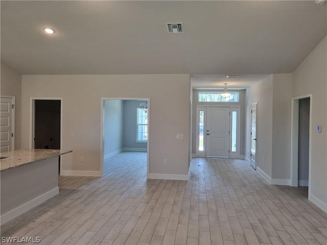 foyer entrance with light hardwood / wood-style floors