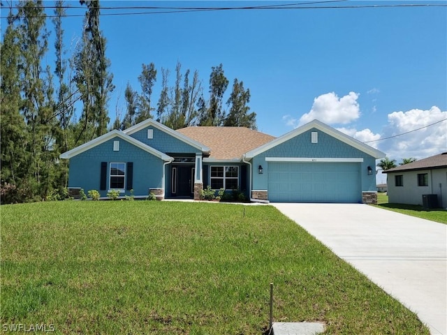 view of front of property featuring a front yard, a garage, and central air condition unit