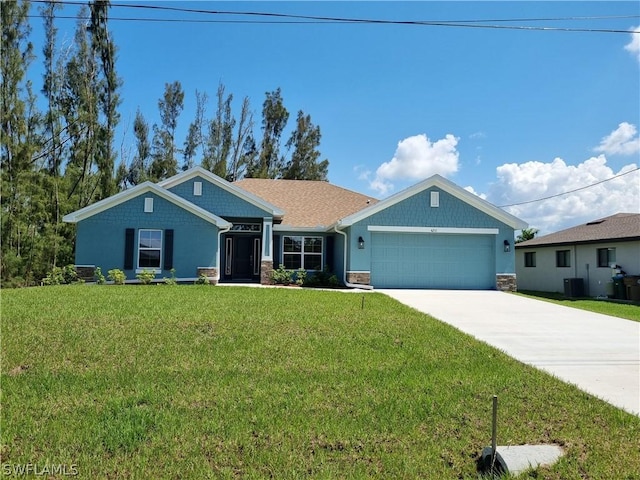 view of front of property featuring a garage and a front lawn