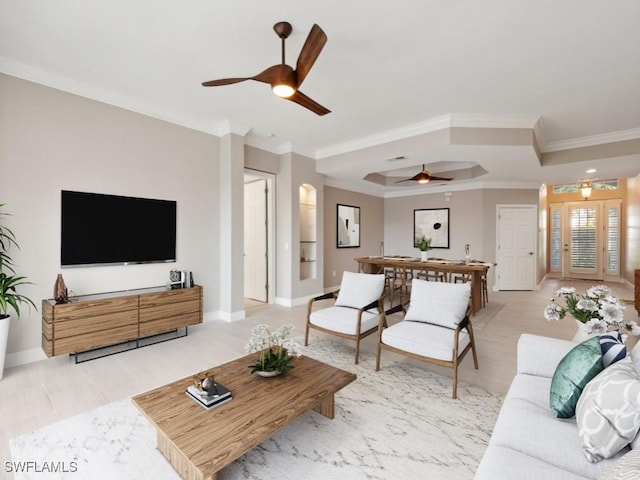 living room with ceiling fan and crown molding