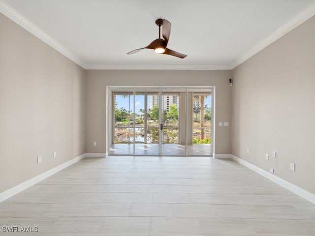 spare room with ceiling fan and crown molding