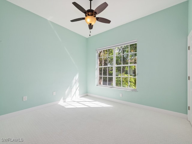 empty room with ceiling fan and light carpet