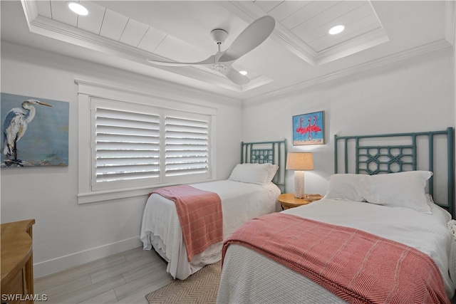 bedroom featuring a tray ceiling, ceiling fan, and light hardwood / wood-style flooring