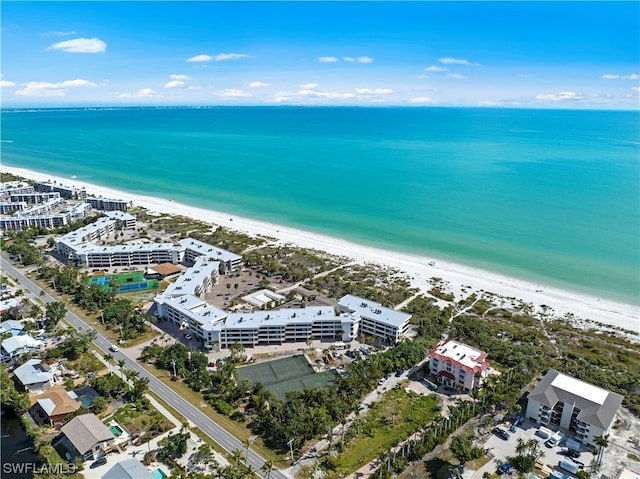 birds eye view of property with a beach view and a water view