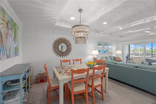 dining space with ornamental molding, a chandelier, light hardwood / wood-style flooring, and beamed ceiling