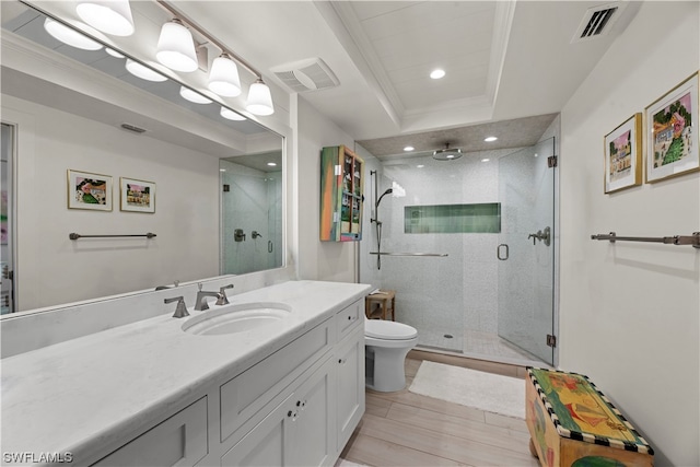 bathroom featuring toilet, oversized vanity, a raised ceiling, tile floors, and an enclosed shower