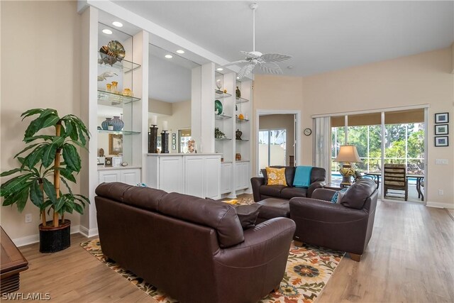 living room with ceiling fan and light hardwood / wood-style floors