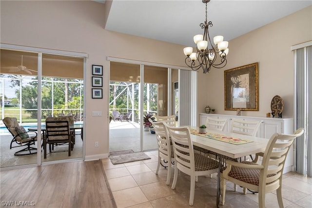 dining area featuring an inviting chandelier and light hardwood / wood-style flooring