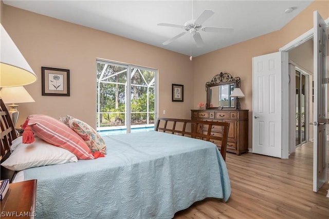 bedroom with access to exterior, ceiling fan, and wood finished floors