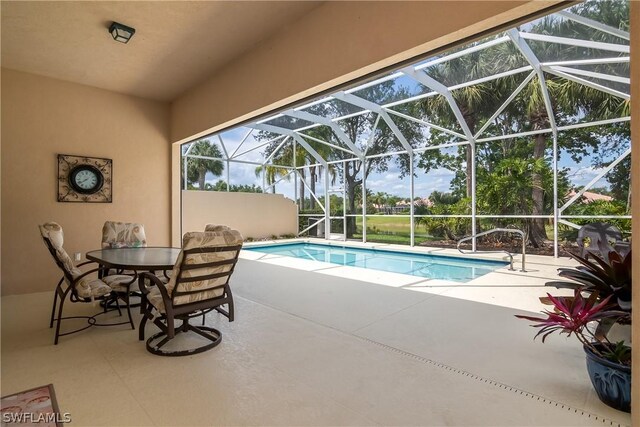 view of swimming pool featuring a lanai and a patio