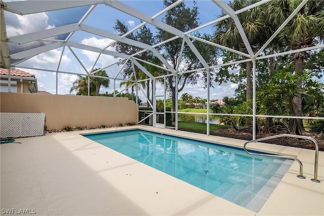 pool with glass enclosure and a patio