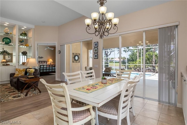 dining room with a chandelier and light tile patterned flooring