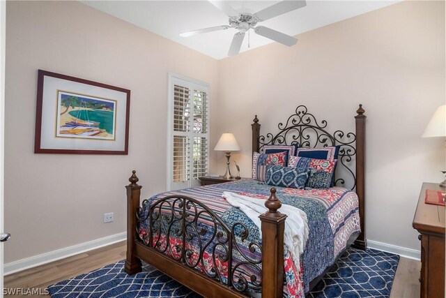 bedroom featuring dark hardwood / wood-style flooring and ceiling fan