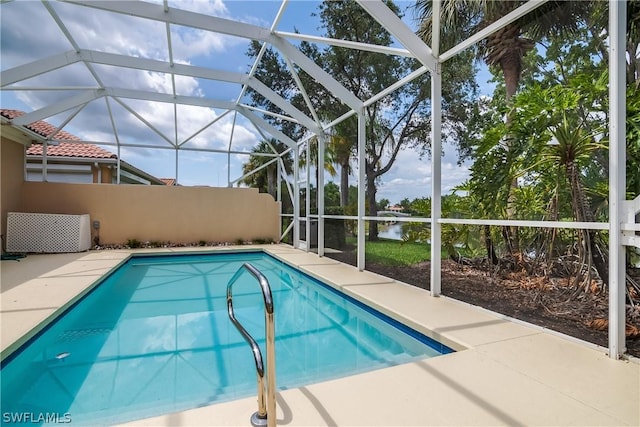 view of swimming pool with a lanai and a patio area