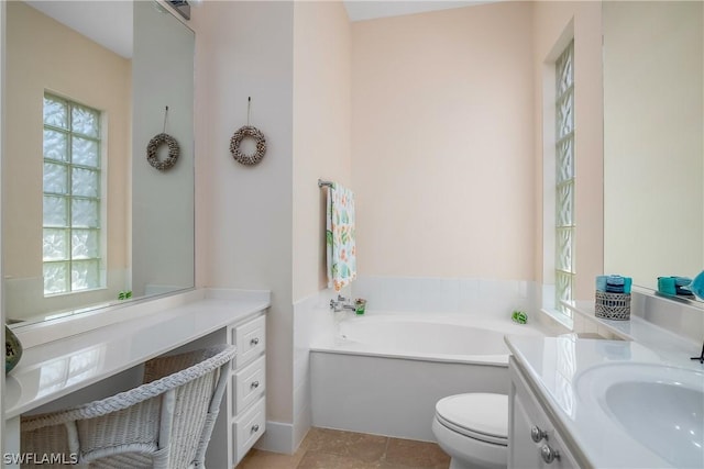 full bathroom with toilet, a garden tub, tile patterned floors, and vanity