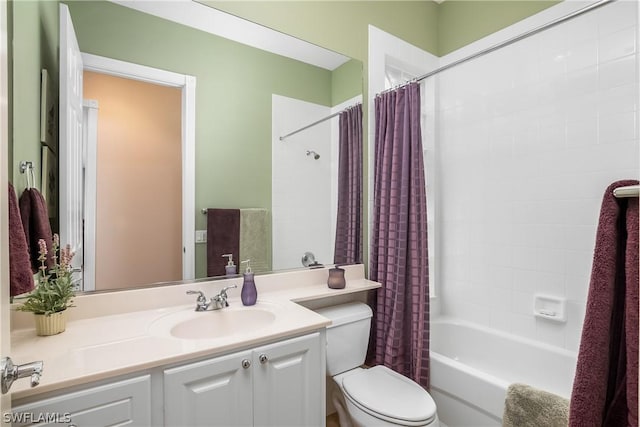 bathroom with toilet, shower / tub combo, and vanity