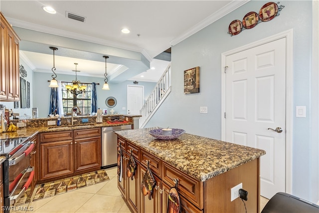 kitchen with appliances with stainless steel finishes, dark stone counters, sink, pendant lighting, and a center island