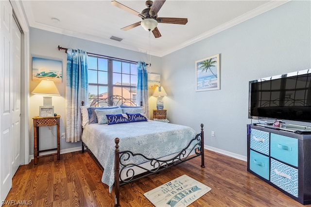 bedroom featuring ornamental molding, ceiling fan, and dark wood-type flooring