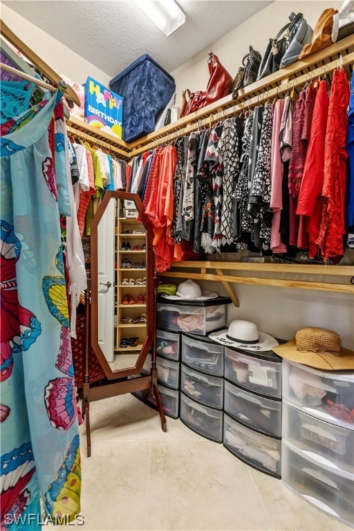 walk in closet with tile patterned floors