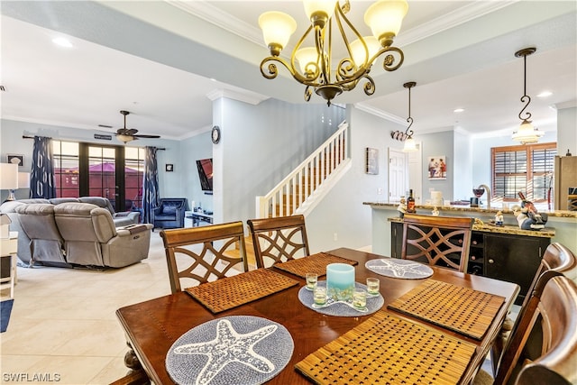 dining space with ceiling fan with notable chandelier, ornamental molding, and light tile patterned flooring